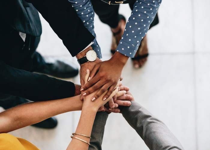 Photo of many hands coming together