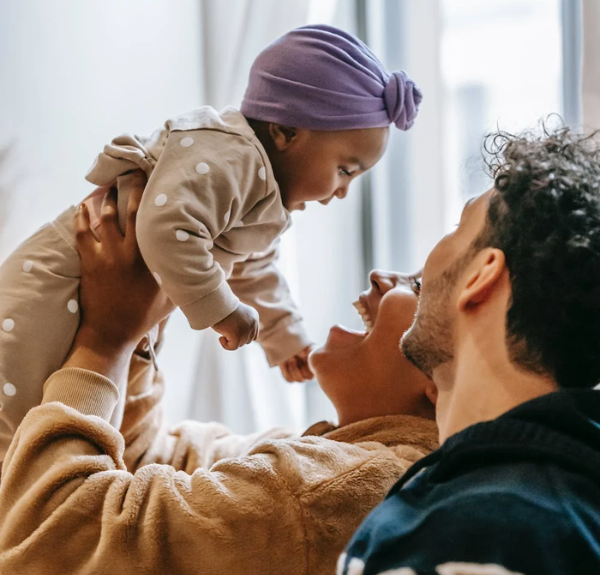 Stock photo of parents and a newborn.