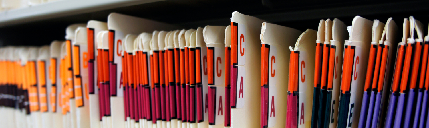 Medical records in file cabinet at doctor's office.