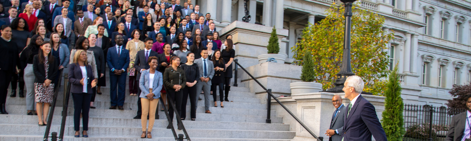 Image of VA Secretary Denis McDonough addressing Veteran Appointees across federal government standing on steps