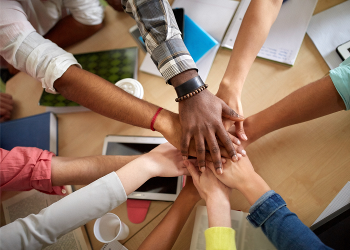 People putting their hands together in a circle