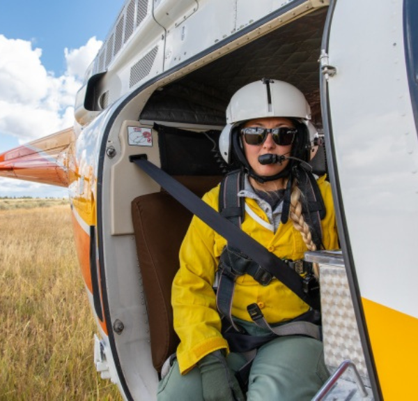 Helitack crew member ready for flight with a plastic sphere dispenser.