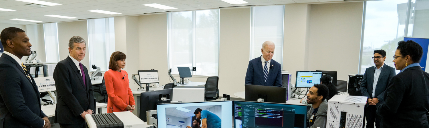 Image of President Joe Biden touring a cybersecurity lab in North Carolina.