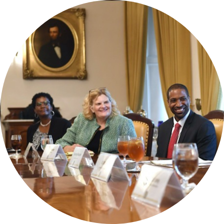 Three people at a conference table