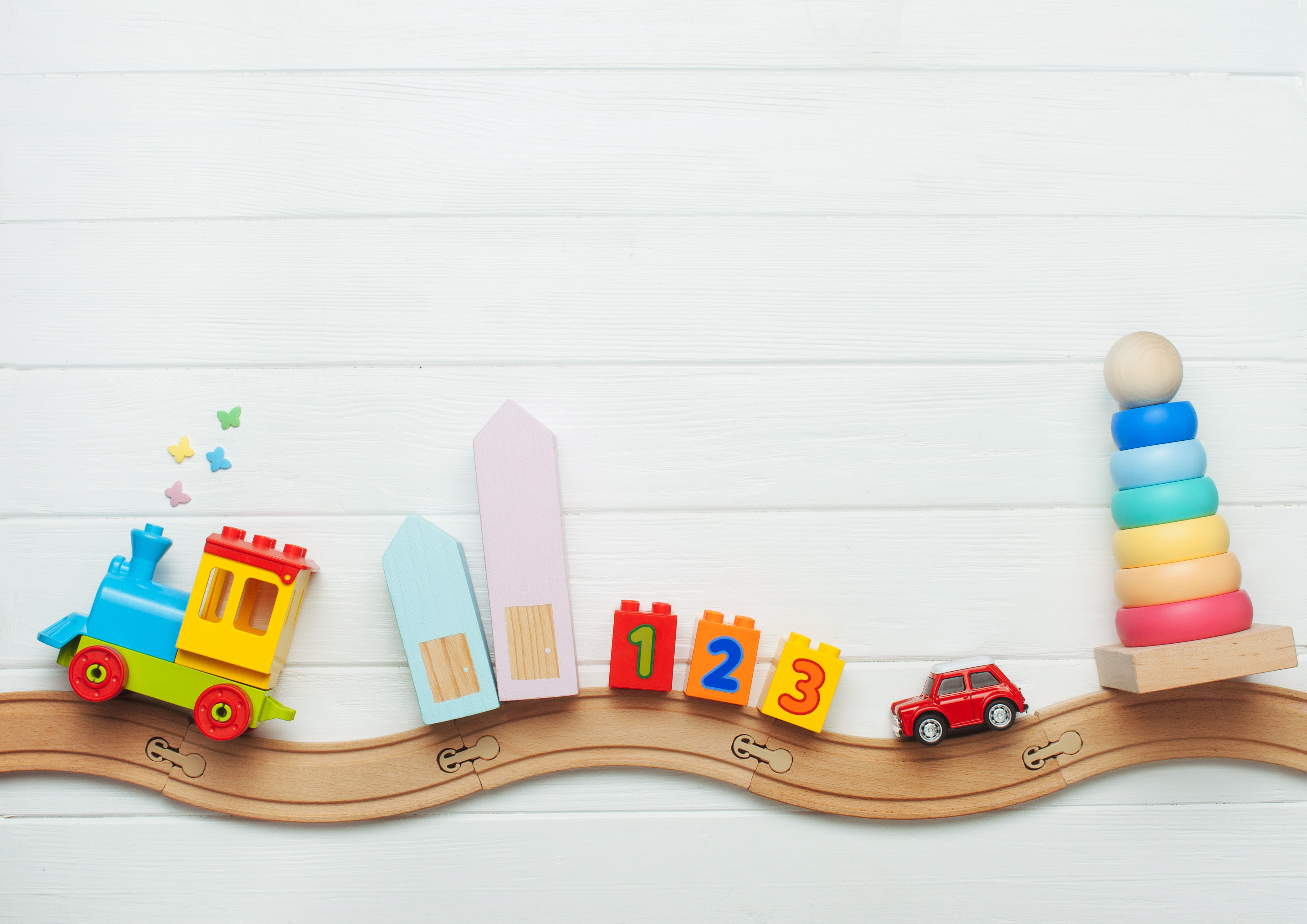 Picture of toys on a wooden train track.